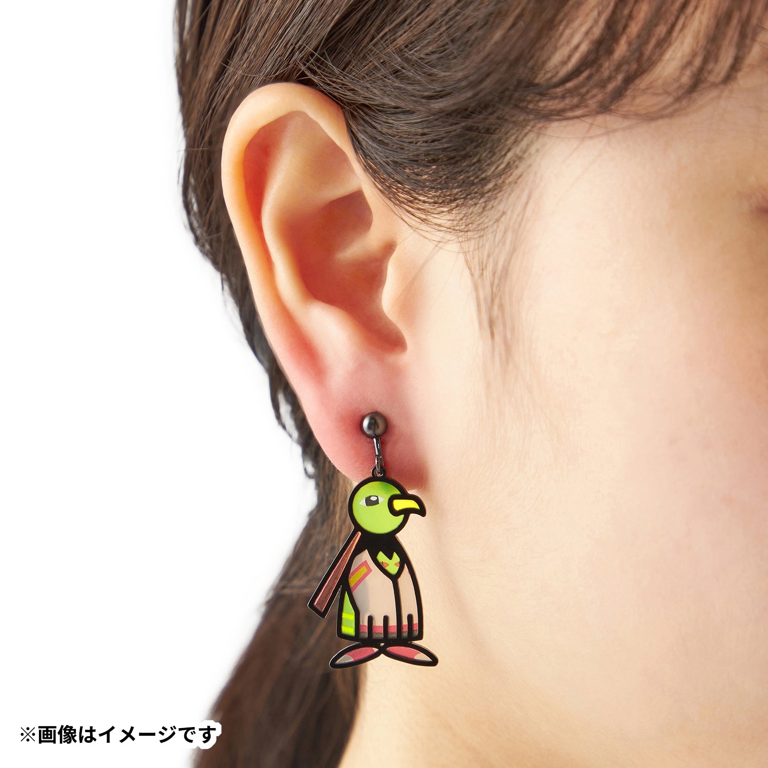 Pokémon Earrings 106 Natio on a display stand with Japanese-themed background
