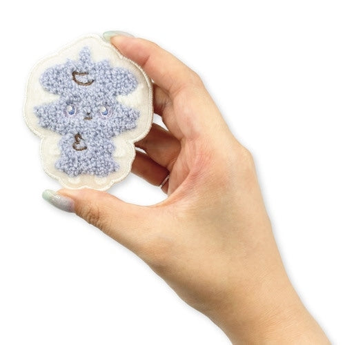 Back of the Espurr pin, showing the Pokémon Center Japan logo, a symbol of authenticity from Japan