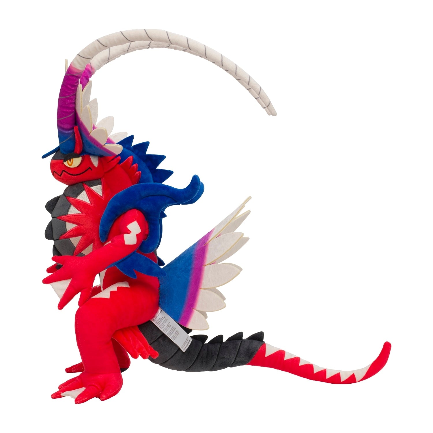 Coraidon plush toy sitting on a shelf from Japan