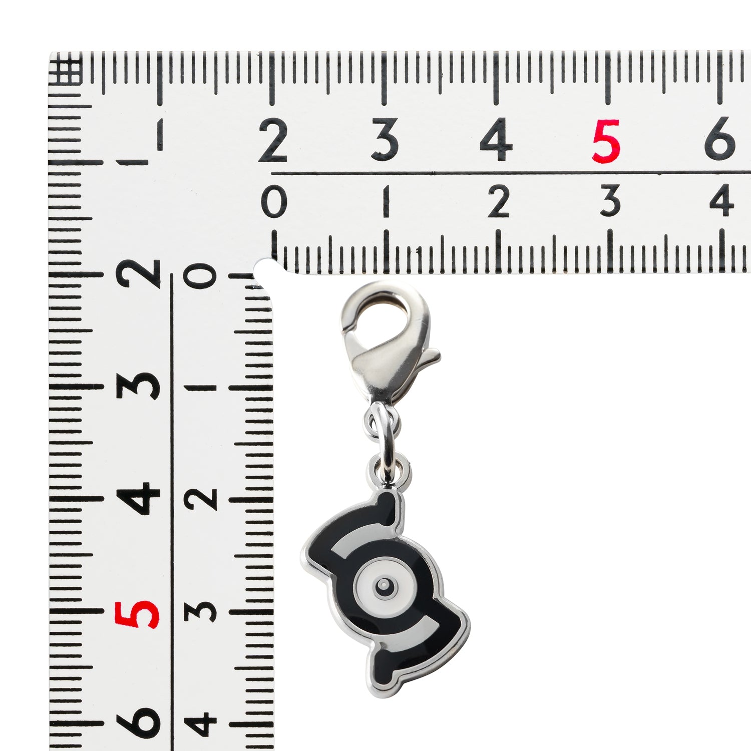 Pokemon Metal Charm 201-S, a small collectible item from Japan with intricate details