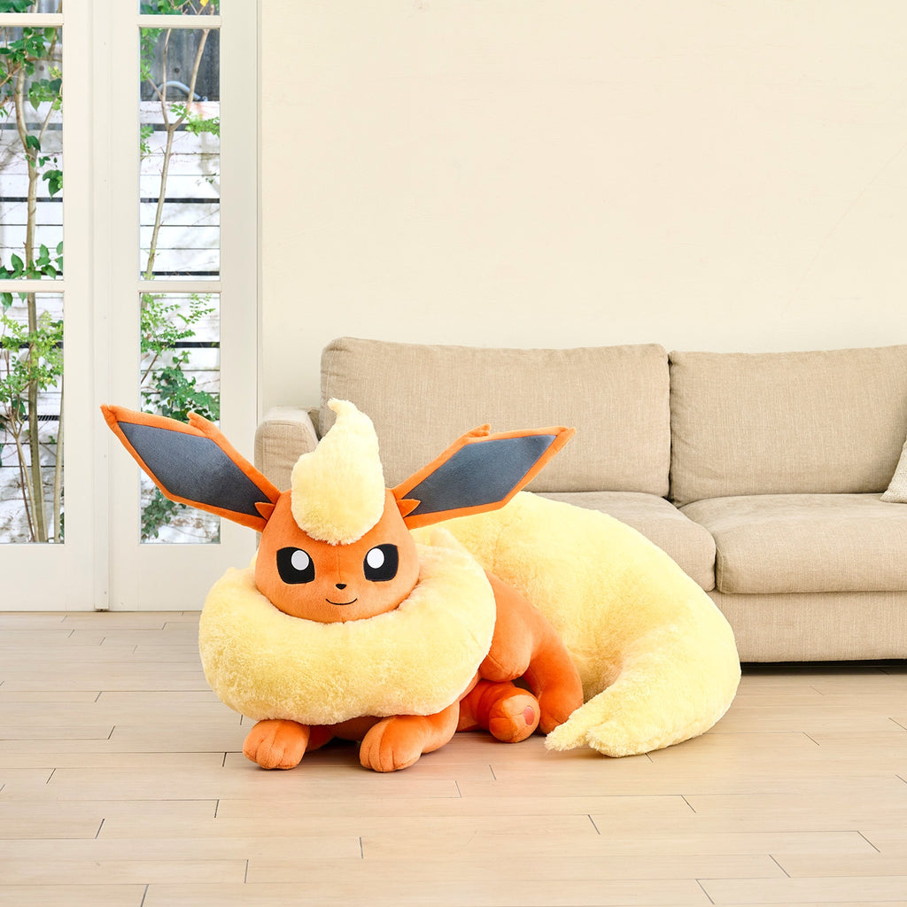 Life-size Pokemon Booster plush from Japan, lying down with cute expression