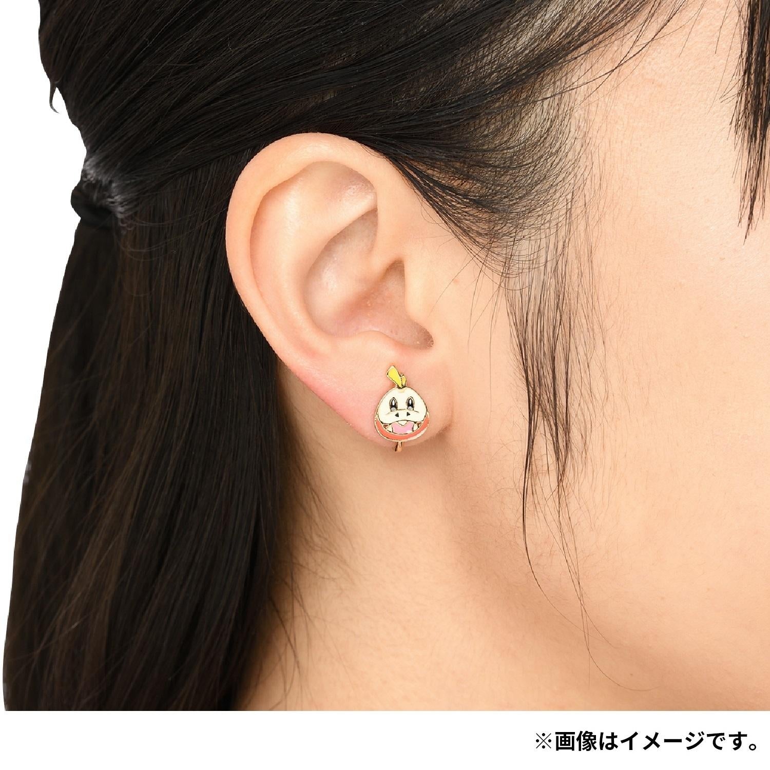 Close-up of Pokémon Hogator earrings with intricate design, shipped from Japan