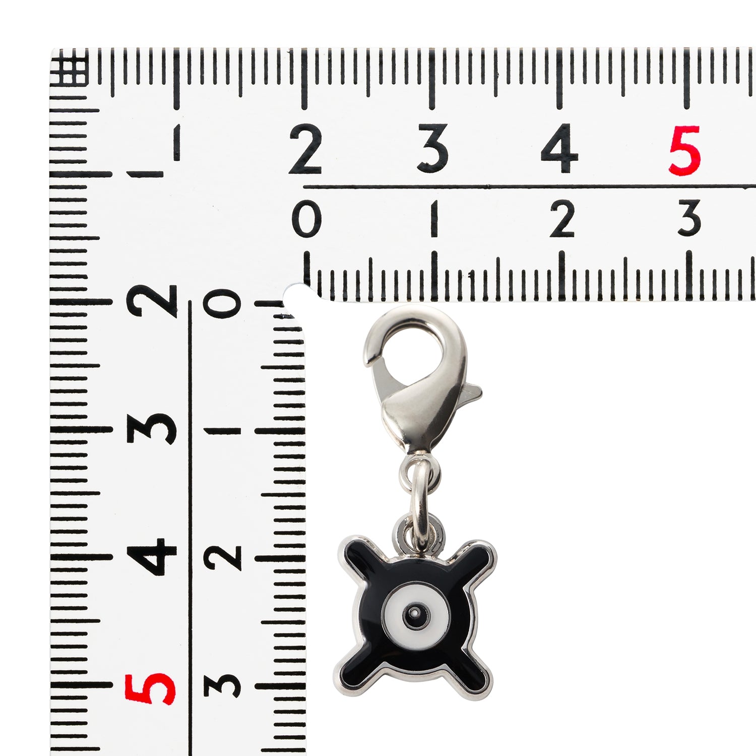 Close-up of Pokemon Metal Charm 201-X with detailed artwork from Japan