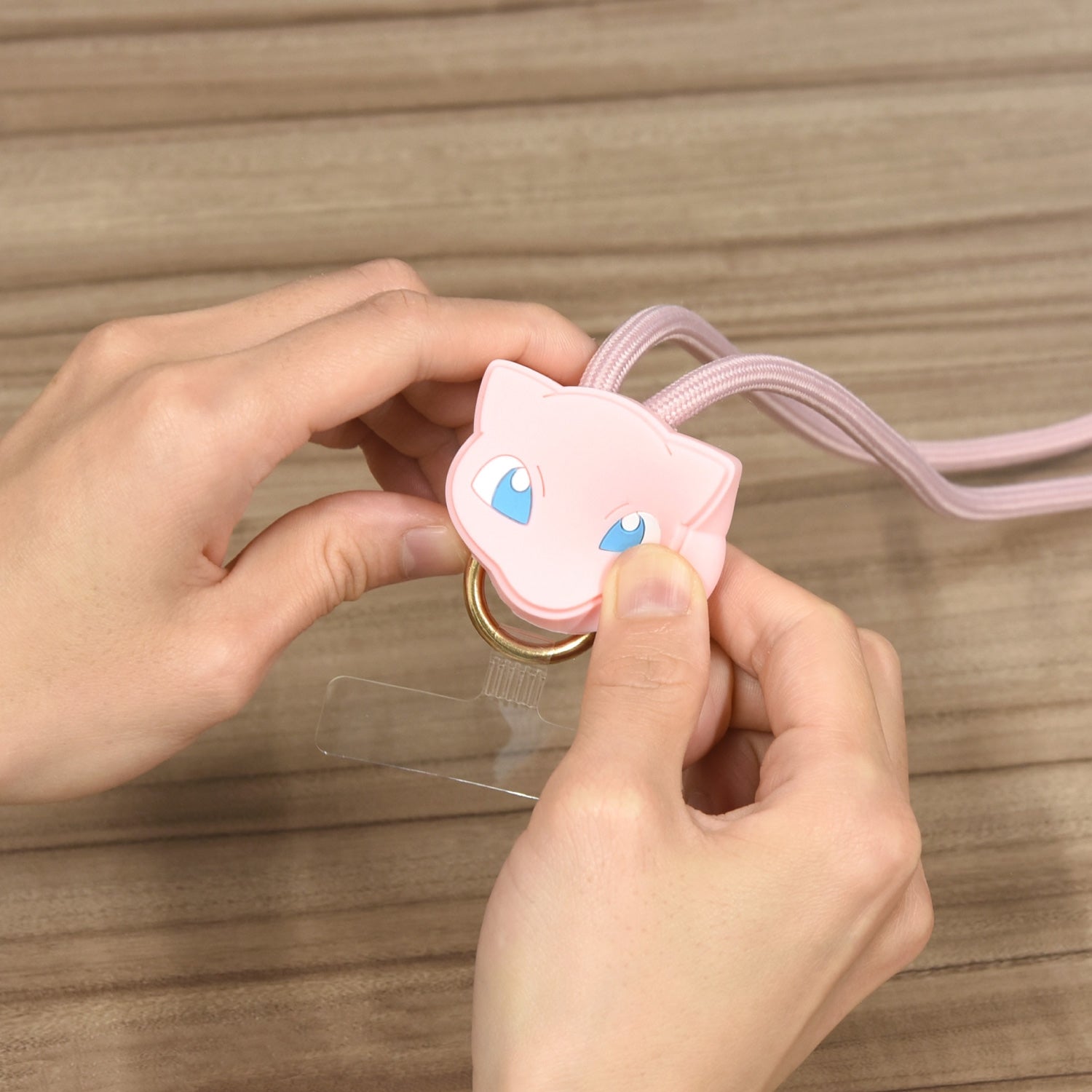 Mew Multi Ring Plus Mascot Strap from Japan, displayed on a phone case with a fun and colorful background