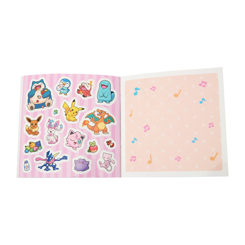 Close-up of POKÉMON SCHOOL sticker book pages with Japanese text and anime-style art